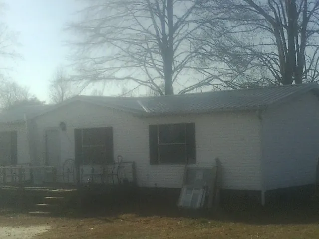New metal roof on a white painted brick home on a foggy morning in Wapwallopen